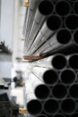 high quality steel pipe or Aluminum and chrome stainless pipes in stack waiting for shipment in warehouse