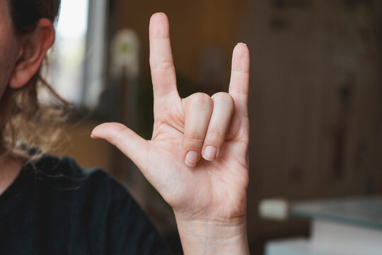 Female hand doing the word love in sign language