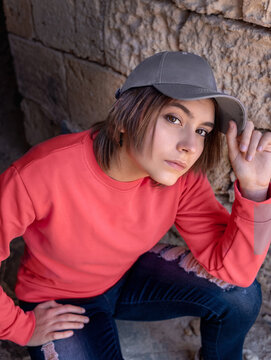 Teenager girl in grey baseball cap and pink long sleeve shirt outdoor, mockup