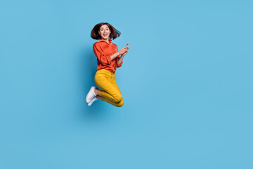 Fototapeta na wymiar Full body profile side photo of young woman jump use mobile like repost fast connection isolated over blue color background