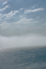 Fototapeta premium The Peninsula of Howth Head on a foggy day, the cliffs warped by fog, Dublin, Seashore of cliffs, bays and rocks landscape, dangerouse cliffs, spectacular views in Ireland , Ireland