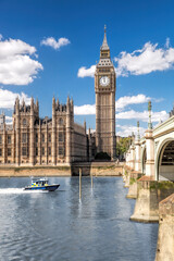 Famous Big Ben with bridge over Thames and tour boat on the river in London, England, UK - 509995027