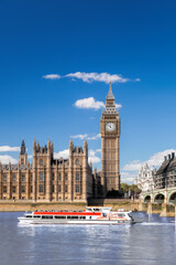 Famous Big Ben with bridge over Thames and tour boat on the river in London, England, UK - 509995034