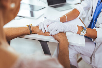 Health worker holding patient's hand. Health worker holding patient's hand. Doctor woman encourage young woman patient by holding hand. I'm here for you