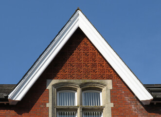 Detail of beautiful gable with ceramic decoration in a house. Historic city of Winchester. England. United Kingdom.