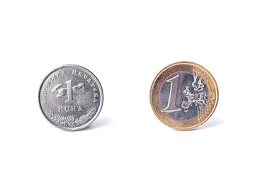 One croatian kuna coin and one Euro coin detailed studio shot.