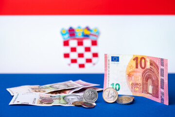 Croatian currency, kuna, together with Euro coins and 10 Euro banknote. Croatia adopted a European currency theme with the Croatian flag motif in the background. - 509996419