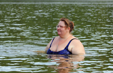 plump woman bath in river body positive
