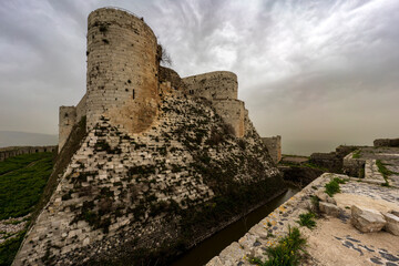 Krak des Chevaliers medieval crusader castle in Syria, a world heritage site. - obrazy, fototapety, plakaty