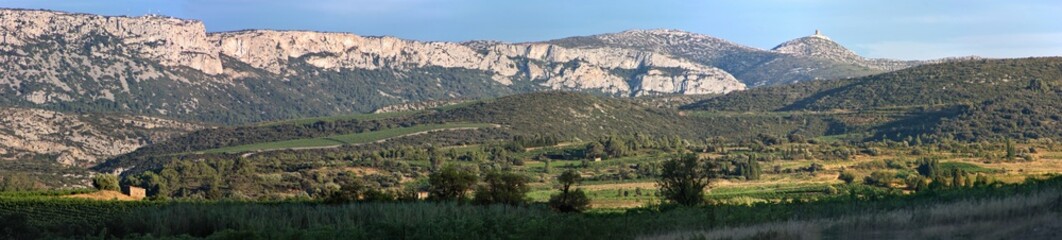 Fototapeta na wymiar Panoramic view of a mountain landscape near Tuchan with the medieval Tour de Far tower in the background, Occitanie region in France