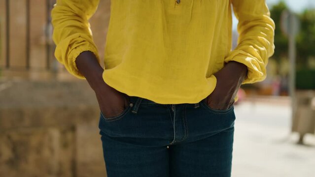 Young african american woman showing empty pockets at street