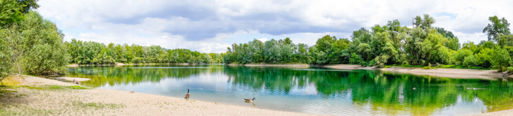Fishing lake near Schwetzingen in Baden-Württemberg. Clear lake with the surrounding nature.
 - obrazy, fototapety, plakaty