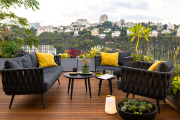 Amazing sun terrace with sofa armchairs, coffee tables, flower pots, planters and wonderful plant