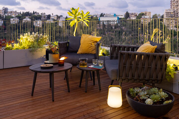 Amazing sun terrace with sofa armchairs, coffee tables, flower pots, planters and wonderful plant