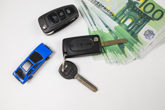  car key euro money and blue toy car, car insurance, sale or rent