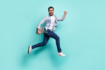 Fototapeta na wymiar Full body photo of delighted overjoyed man hurry running jump isolated on teal color background