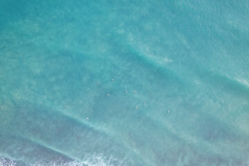 Amazing aerial view Top down of waves break on tropical sea Surfers with surfing boards Aerial...