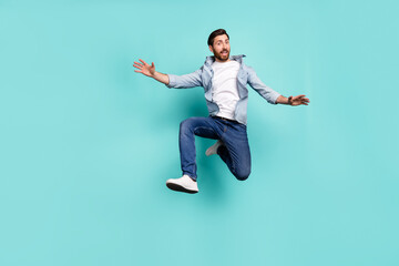 Fototapeta na wymiar Full body photo of satisfied sportive person jumping enjoy free time isolated on teal color background