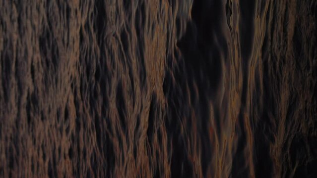4k stock vertical orientated video footage of abstract nature liquid background. Gradient natural colors of dramatic sunset blue sea waves. Brown sunset sea water backdrop