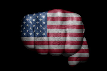 Flag of America painted on strong fist on black background