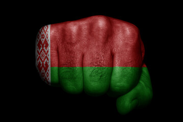 Flag of Belarus painted on strong fist on black background