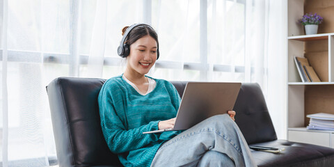 Attractive asian woman relaxing on the sofa.