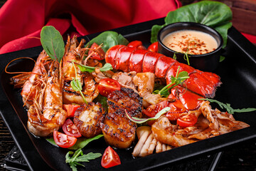 grilled lobster tail with seafood shrimp scallops clams tomato salad 