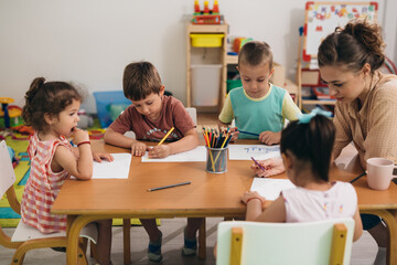 group of kids drawing in kindergarden