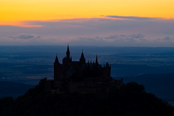 Historic castle silhouette on a hill in Germany near Hechingen south of Stuttgart at evening blue...