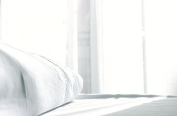 close up photo of pillow and sheets at morning sunrise in the bedroom. vintage filtered