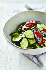 Cucumber sald with chili pepper, sesame and red onion. Thai inspired
