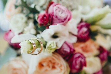 Wedding rings on a bouquet, closeup.