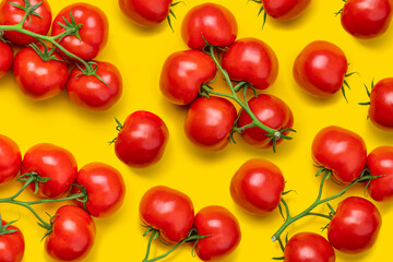 Tomato on a branch sprout top view flatlay on a yellow background. Fresh juicy ripe tomato Red Cherry fruits. Salad preparation ingredients. Pattern