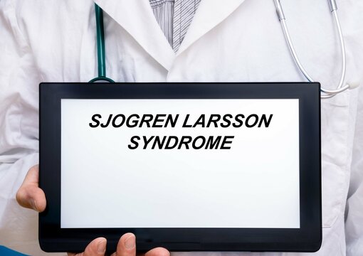 Sjogren Larsson Syndrome.  Doctor with rare or orphan disease text on tablet screen Sjogren Larsson Syndrome