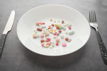 close up of colorful pills on plate 