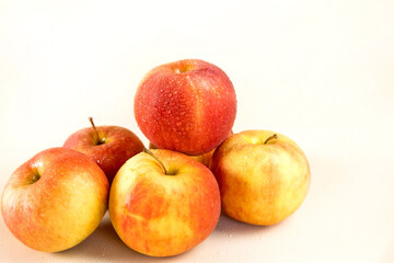 a bunch of red apples on a light background
