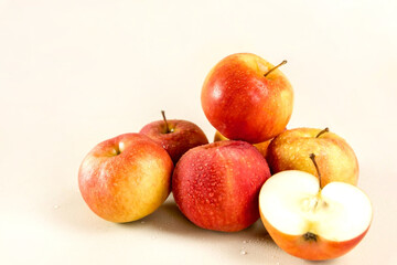 A bunch of red apples on a light background. cut apple
