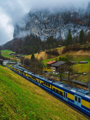 Swiss train and traditional houses in Lauterbrunnen, Switzerland