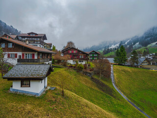 Fototapeta na wymiar Swiss traditional houses on the hill in Lauterbrunnen, Switzerland
