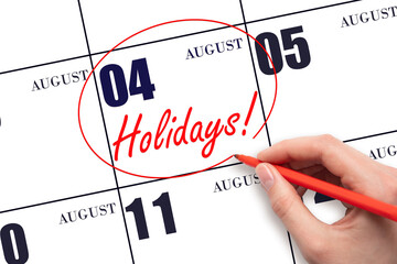 Hand drawing a red circle and writing the text Holidays on the calendar date 4 August. Important date.