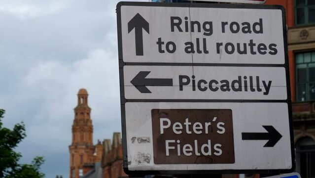Close up of traffic and tourist direction sign or board showing way to Manchester Piccadilly station, ring road and Peter's Fields.