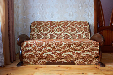 old sofa in the room,stylish sofa for relaxing with a wooden handrail