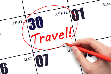 Hand drawing a red circle and writing the text TRAVEL on the calendar date 30 April. Travel...