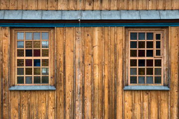 Obraz na płótnie Canvas A wooden window in the church, an antique window, an old window frame and old panes. A beautiful, intimate facility, all built of wood. It was established many years ago.