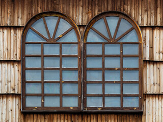 A wooden window in the church, an antique window, an old window frame and old panes. A beautiful, intimate facility, all built of wood. It was established many years ago.