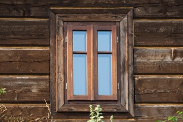 A wooden window in the church, an antique window, an old window frame and old panes. A beautiful, intimate facility, all built of wood. It was established many years ago. - obrazy, fototapety, plakaty