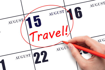 Hand drawing a red circle and writing the text TRAVEL on the calendar date 15 August. Travel...