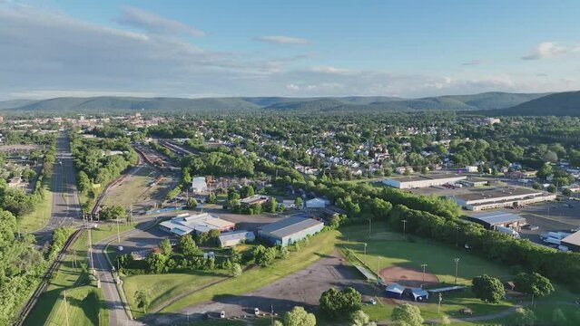 Late afternoon spring, summer aerial video of area around Elmira New York