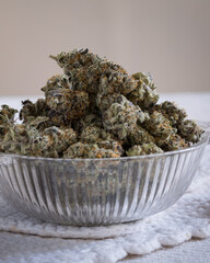 Dried and trimmed cannabis buds. Green marijuana buds with light natural background