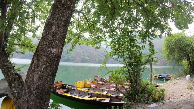 Rowing boats moored on a shore of Sattal Lake